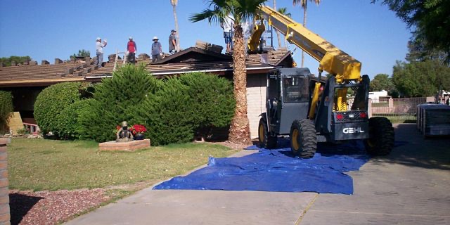 Boom lift delivering roof tile to a Phillips Roofing job site in the Valley