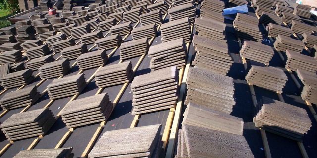 Concrete roof tiles staged across a roof during a Phillips Roofing reroof