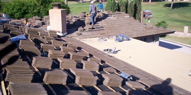 Two Phillips Roofing roofers installing concrete tile on a Scottsdale roof
